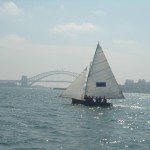 Classic early 20th century skiff sailing on Sydney harbor 2005.