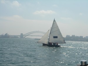 Classic early 20th century skiff sailing on Sydney harbor 2005.